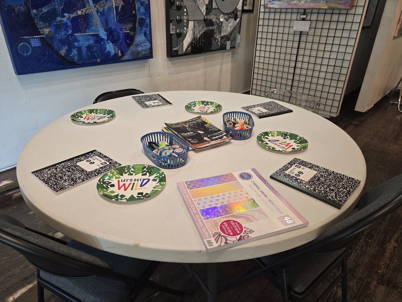 A craft table covered with markers, magazines, and tissue paper during the session.